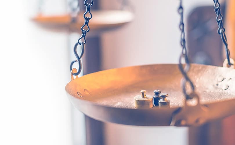 who-we-are-balance-kerioth small weights on a large brass scale